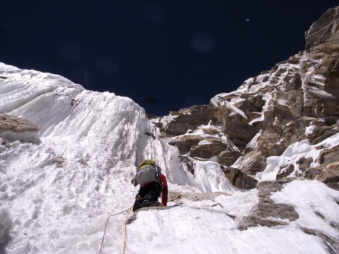 Kei Taniguchi heads toward vertical ice in the first crux section of the route. Sun-warmed, rotten ice made for delicate and time-consuming climbing. 
