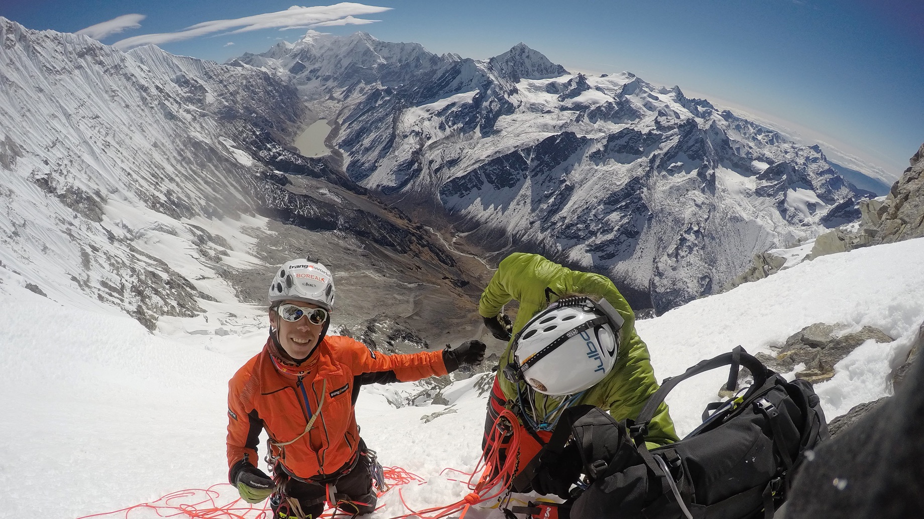 Manu Cordova and Jordi Corominas on the south face of Chekigo. On the left, the fluted snow slopes form part of the southwest face of Kang Nachugo. In the valley lies the glacial lake of Chugima Pokhari. To the south lie (A) Likhu Chuli East (6,719m); (B) Likhu Chuli West (6,659m); (C) Chugimago North (5,945m); (D) Chugimago (6,258m); (E) Peak 5,794m; (F) Ramdung (ca 5,925m); (G) Peak 5,699m; and (H) Yalung Ri (5,647m).  