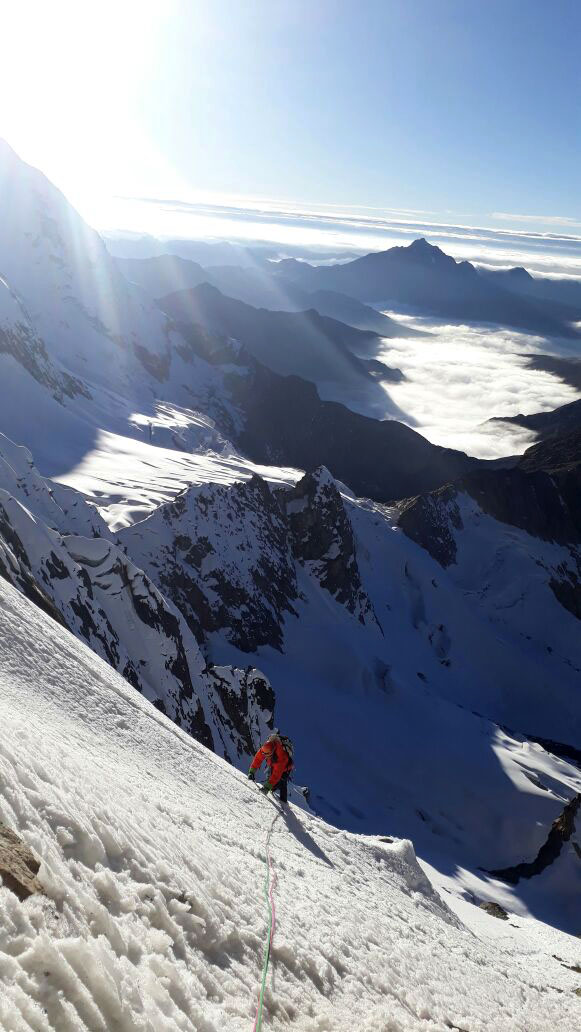 Climbing snow slopes on the southeast face of Tunsho Sur. 