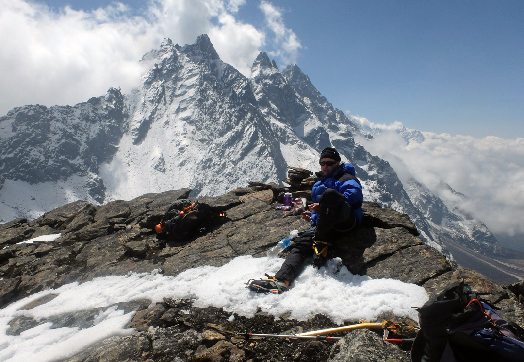 Gerry Galligan on top of the rock tower on the west ridge of Phuletate, looking east toward the summit. 