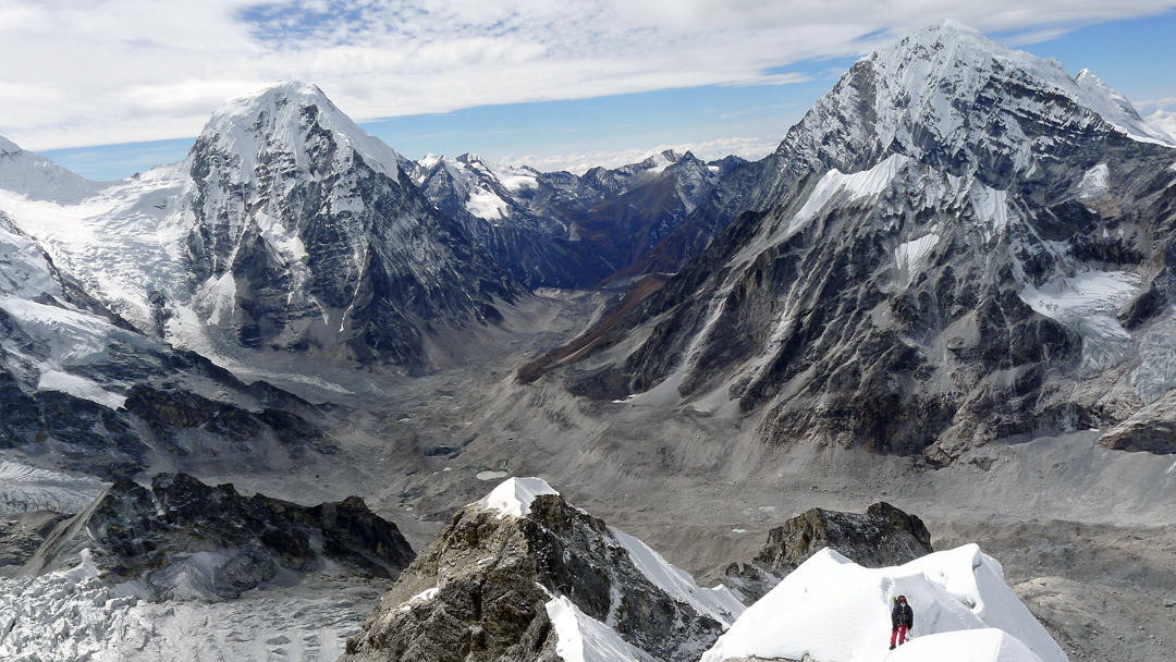 Mikel Zabalza on the southwest ridge of Drangnag Ri, with the Rolwaling Glacier below and the two big peaks of Chobutse (6,686m, left) and Kang Nachugo (6,737m).  