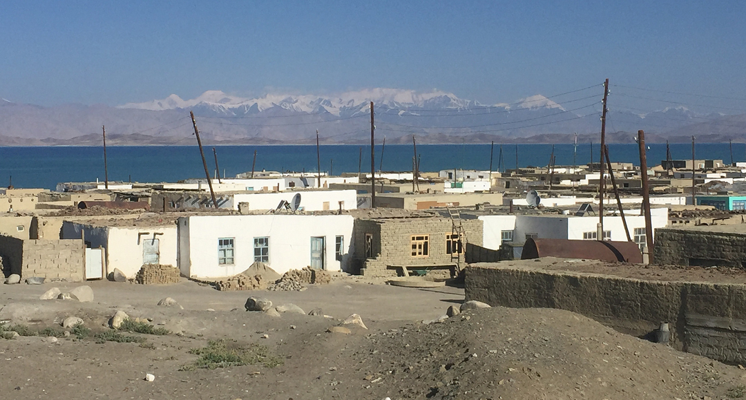 A village on Karakul Lake with the high Pamir behind. 