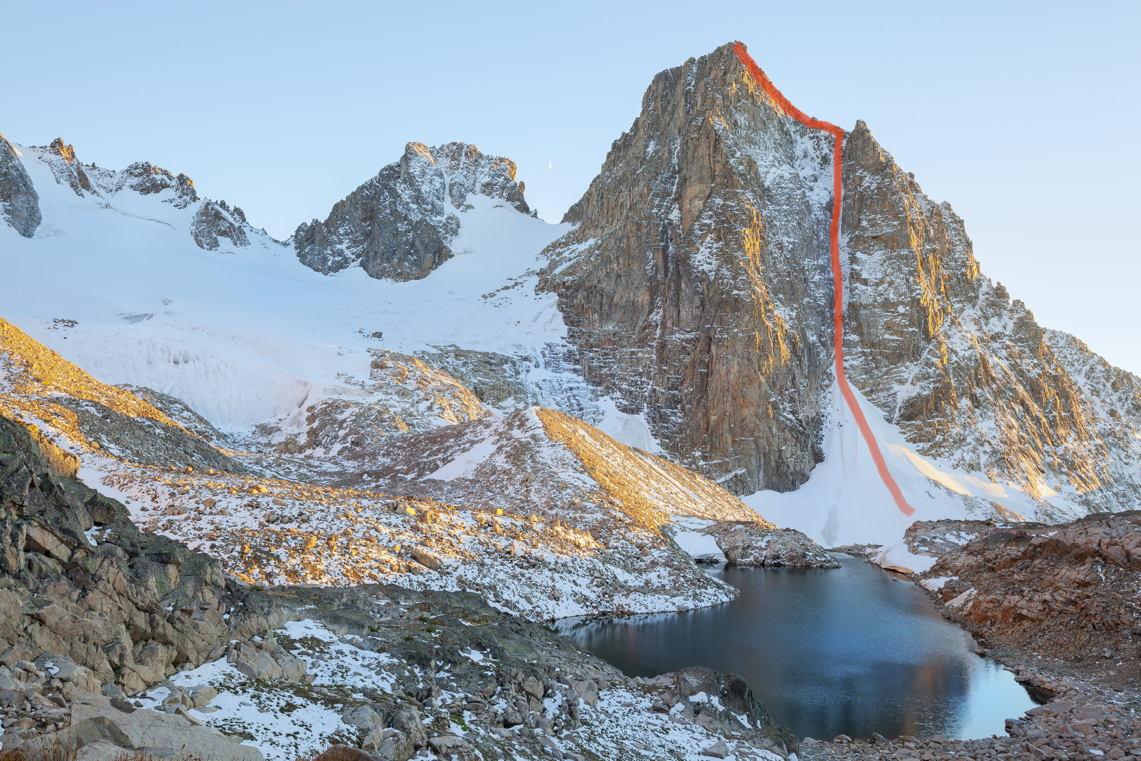 The north face of Wolf Mountain in autumn condition. The Northwest Couloir (1,700’, IV AI4 M5) follows the obvious snow-filled cleft on the right side of the photo. 