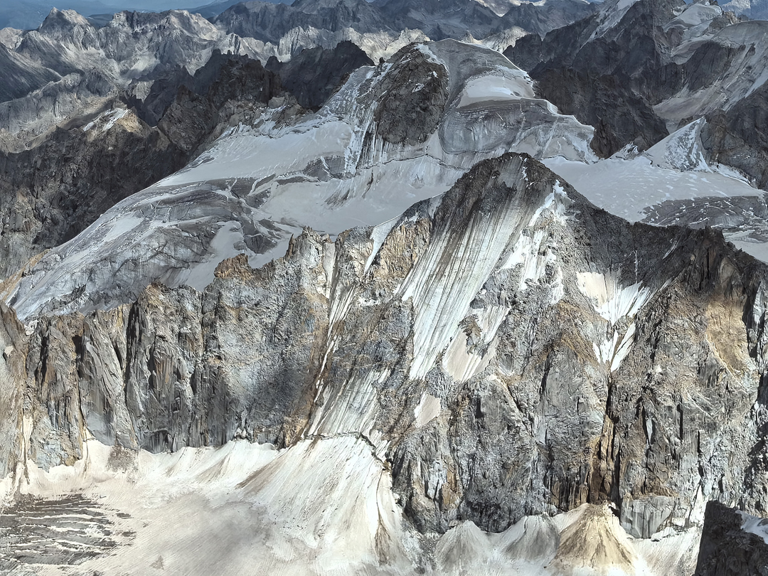 In the foreground is unnamed and unclimbed peak seen from the north ridge of Zhuqing. Behind is the more glaciated Peak 5,679m, attempted in 2023.  
