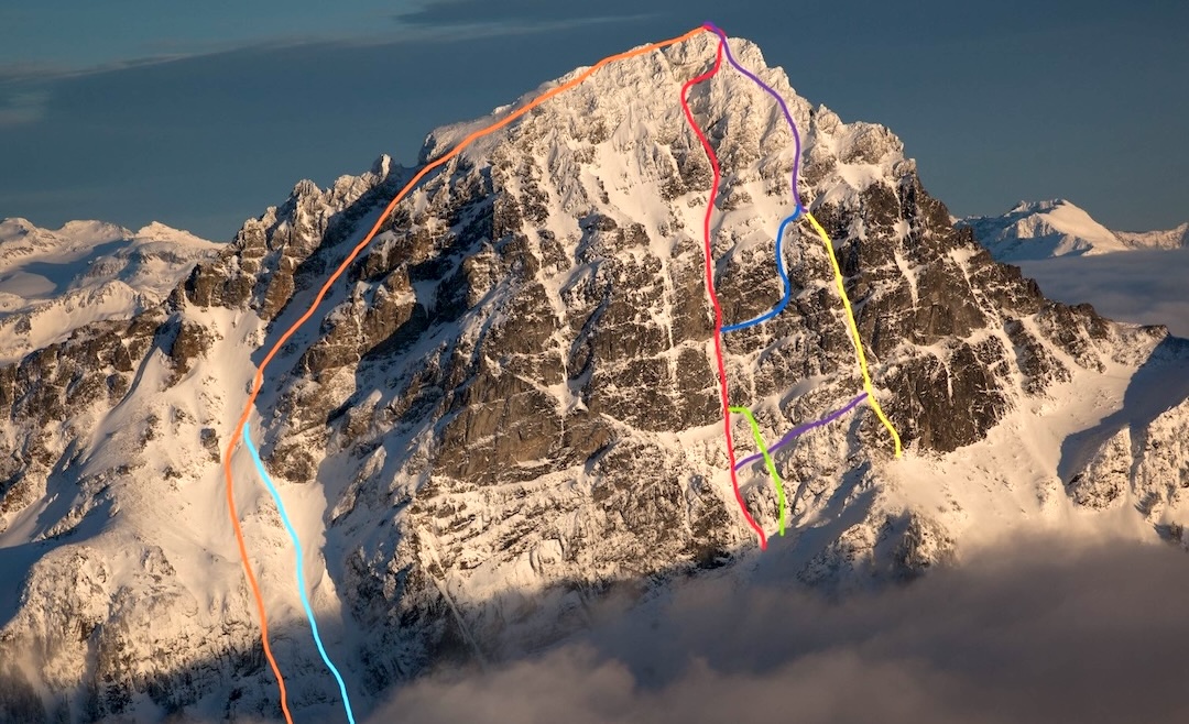 In red: Borrowed Time (1,900’, IV WI5 M7). Climbed by Justin Sackett and Michael Telstad on January 19, 2025, Borrowed Time follows the opening pitches of the Merrill-Minton (red-blue-purple) before tackling new terrain on the west face of Sloan Peak. Yellow to purple: Superalpine was the first winter route on the west face. Orange: Full Moon Fever (3,000’, IV 5.8 AI4), on the northwest aspect, was the first winter ascent from this side of the mountain.