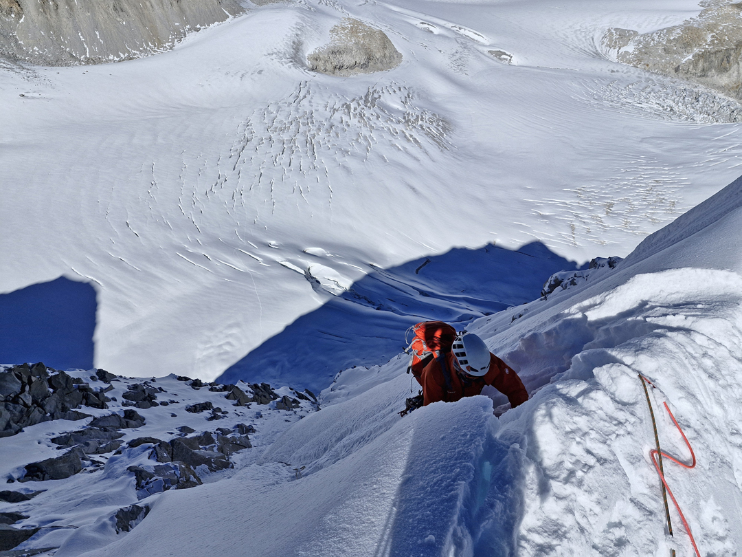 Emerging from the north face of Peak 6,119m onto the summit ridge with the Angsi Glacier Basin below. 