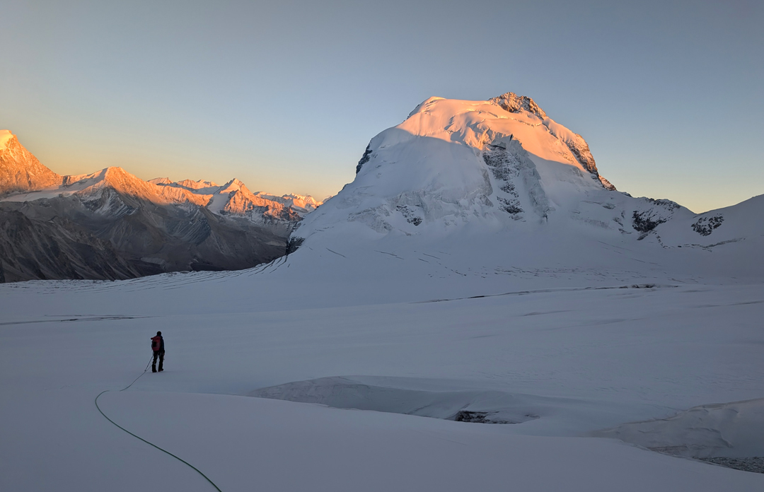 Setting off at dawn across the Angsi Glacier basin for Peak 6,013m, which was climbed by the left (north) ridge.