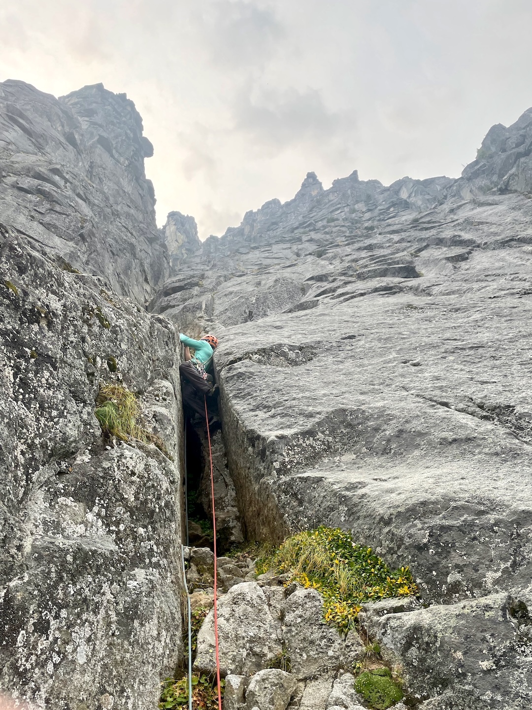 Sean Reckert leading the fifth pitch of Ripped Settee, chimneying on the left side of the central buttress. The route continued up the clean granite above.