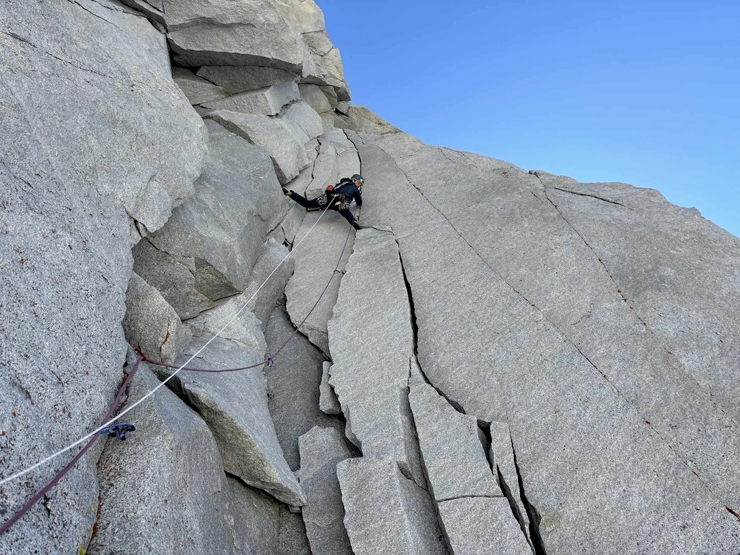 Matt Carpenter leading up the steep third pitch (5.10) through the namesake heart-shaped feature of Heart of Darkness (1,100’, 9 pitches, IV 5.11-), Merriam Peak, Sierra Nevada, California.