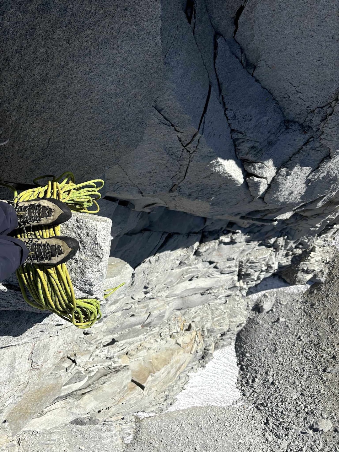 Daniel Dunn looking down from the diving board belay at the top of pitch three on Heart of Darkness, Merriam Peak.