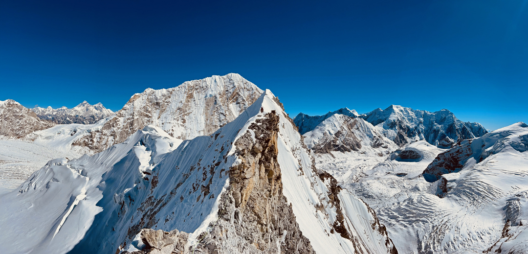 On the east ridge of Takargo. Behind is the west face of Tengi Ragi Tau. Immediately right, with slanting rock bands, is the west face of Pacharmo. Right again is Linkhu Chuli with Linkhu Chuli II on the far right with its north spur facing the camera.