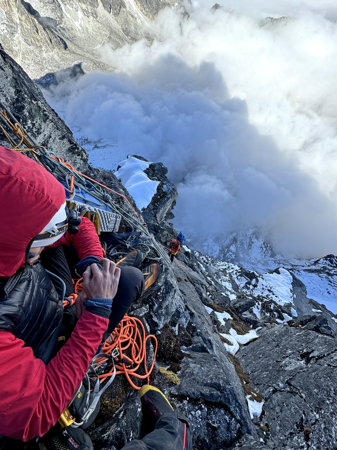 Seen from a belay on the east face of Kyajo Ri, cloud bubbles up from the Dudh Kosi (a.k.a. Gokyo) valley.