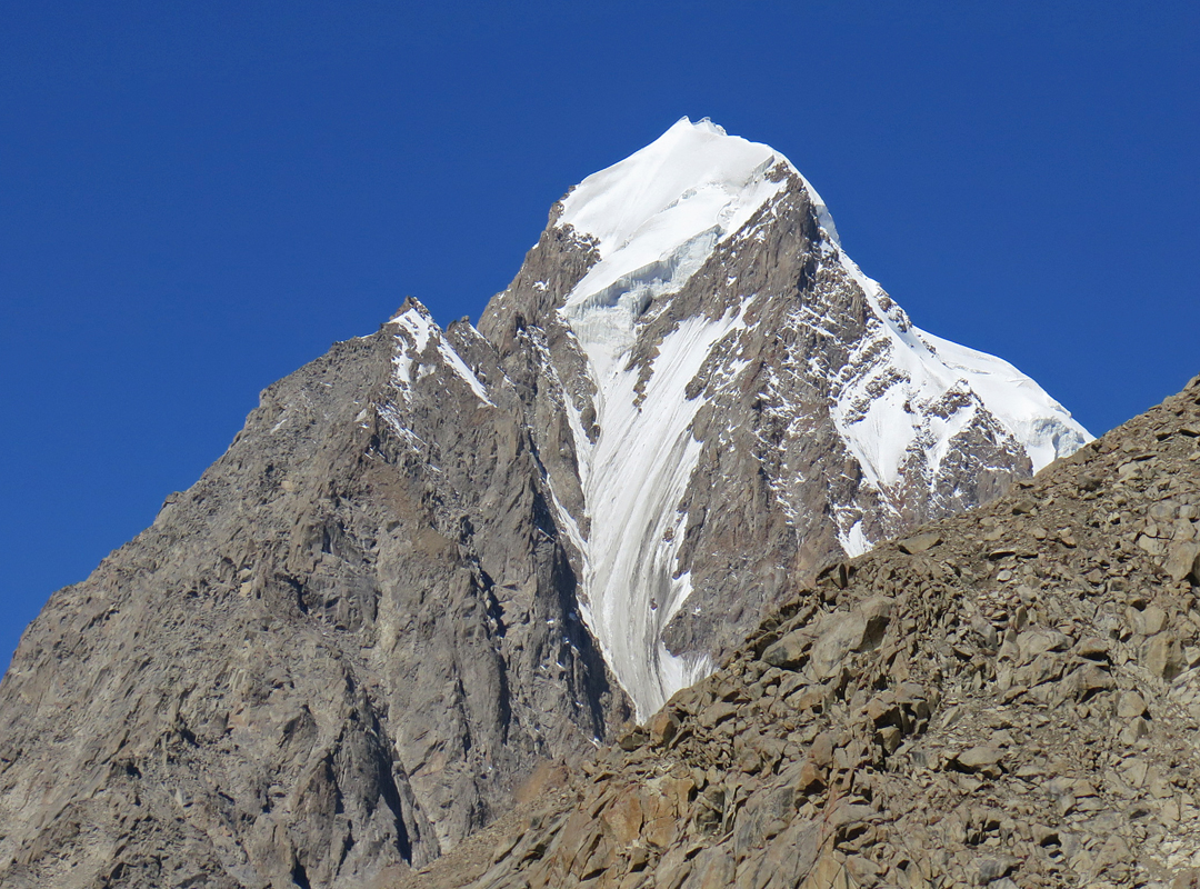 The first-ascent route traversed the right skyline from a high col.