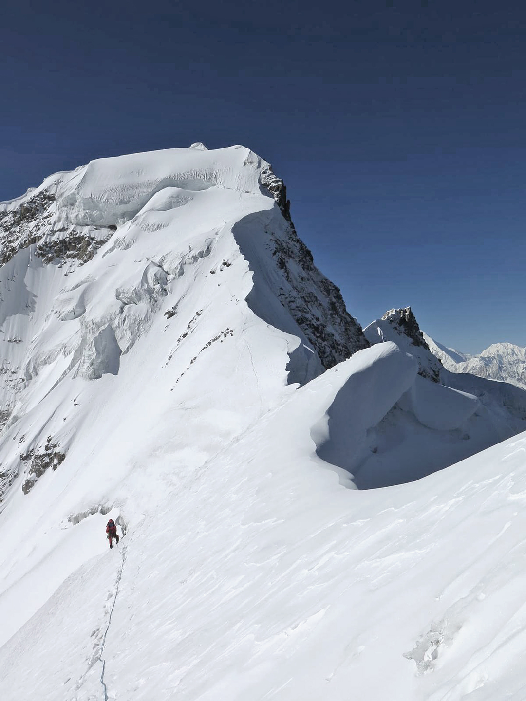 Louis Rousseau returning from the first ascent of Naseer Baig I. Behind and above him is the col, close to which Adam Bielecki and Rousseau had their top bivouac.