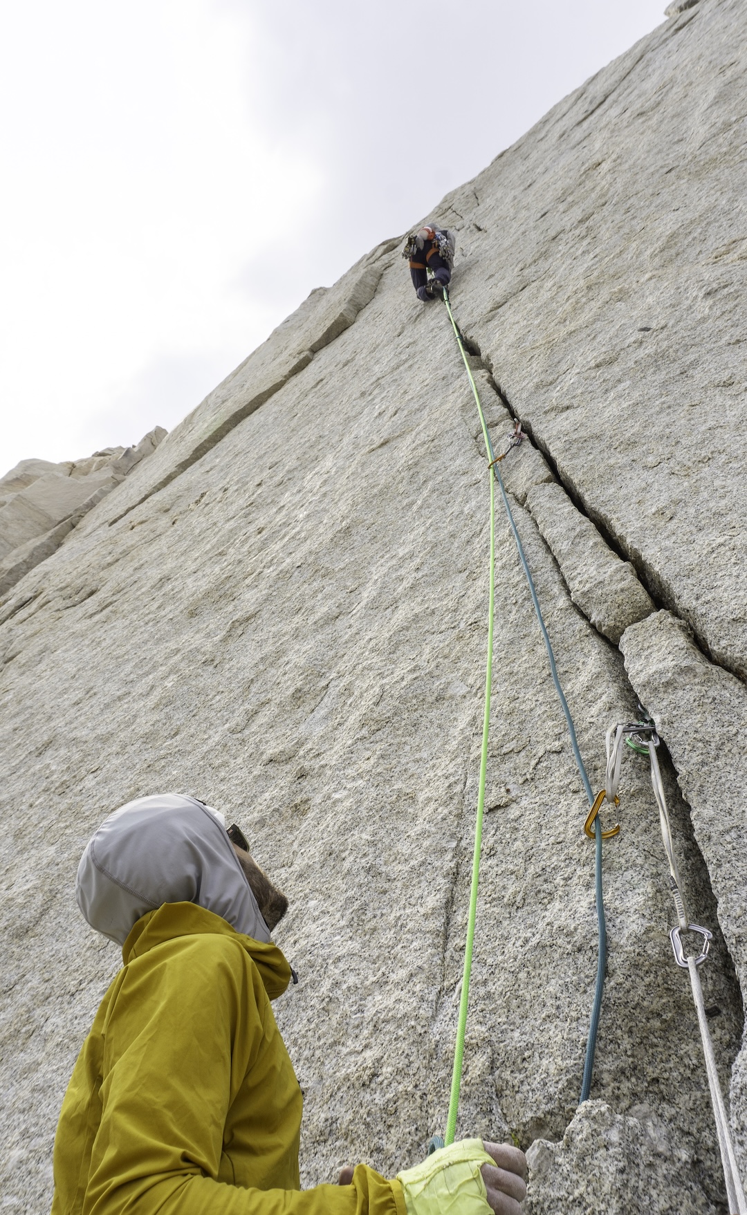 Japhy Dhungana leading one of the headwall pitches of Sapphire Crack (700’, 5.11d) on Sky Blue Spire, with Zach Lovell belaying.