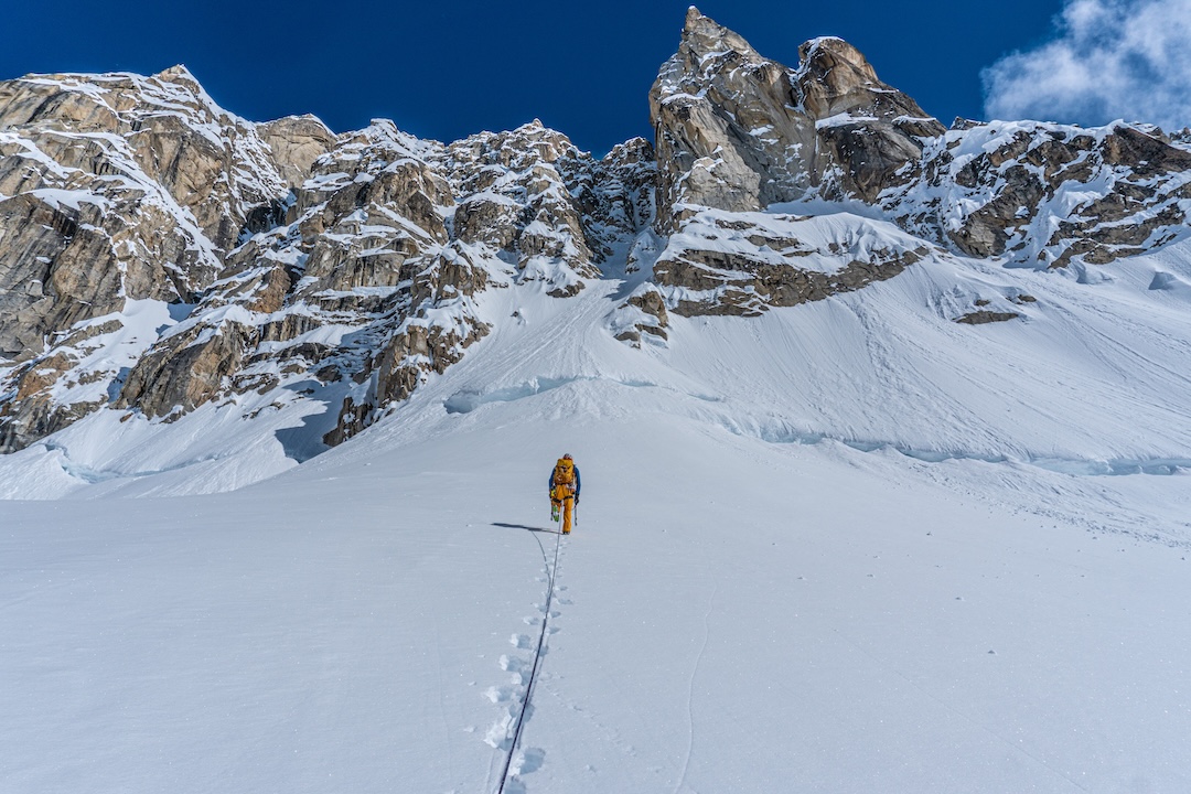 Chris Dewey leading up to the bergschrund below Depth Perception on the west face of the Water Tower. The bottom half of the route and the crux can be seen above in the shadow.