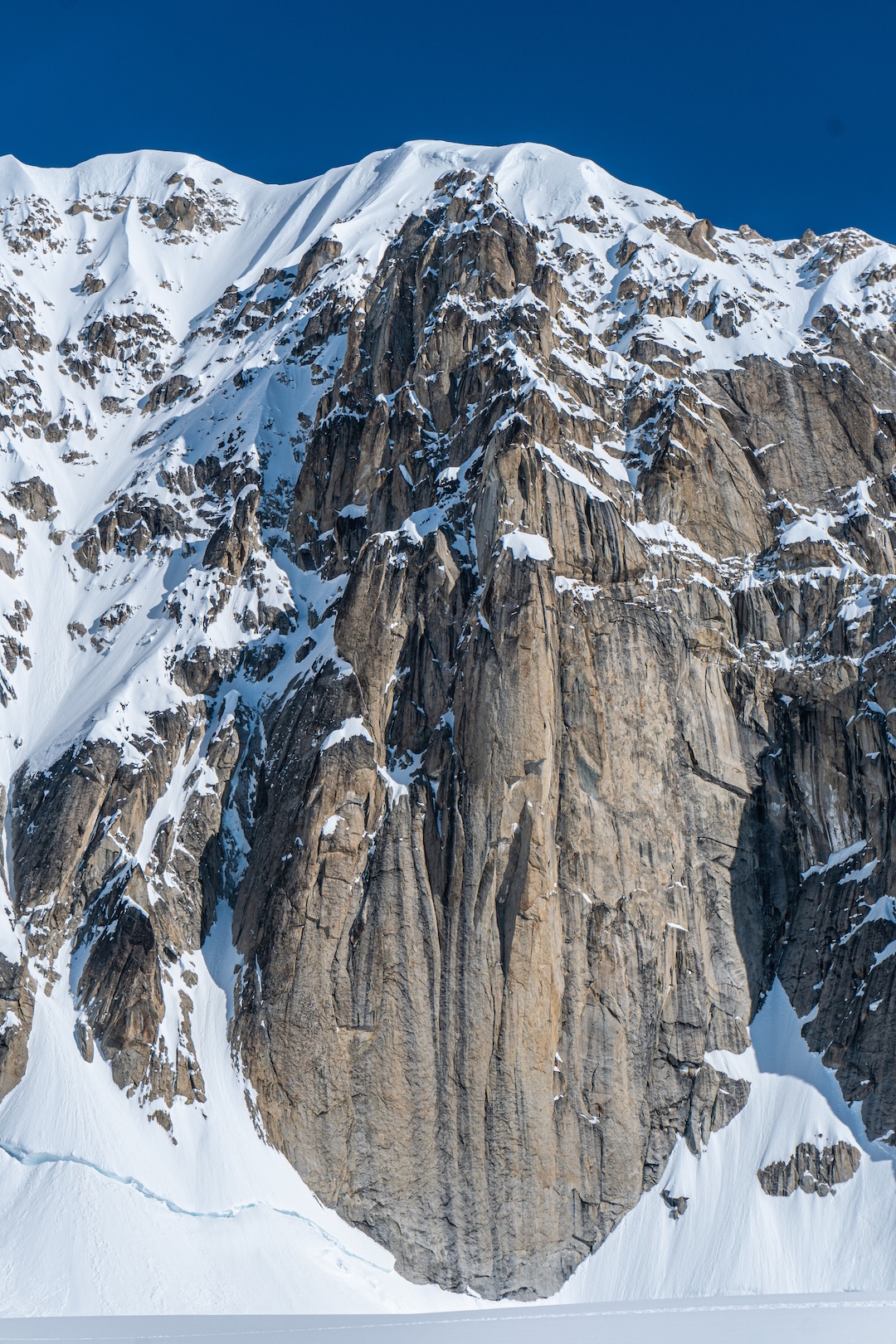 An unclimbed feature on the northern border of the cirque below the Southeast Spur of Begguya. This buttress is around 1,500 feet tall. There is plenty of potential for new routes in the cirque if you can find a pilot willing to land you there. 