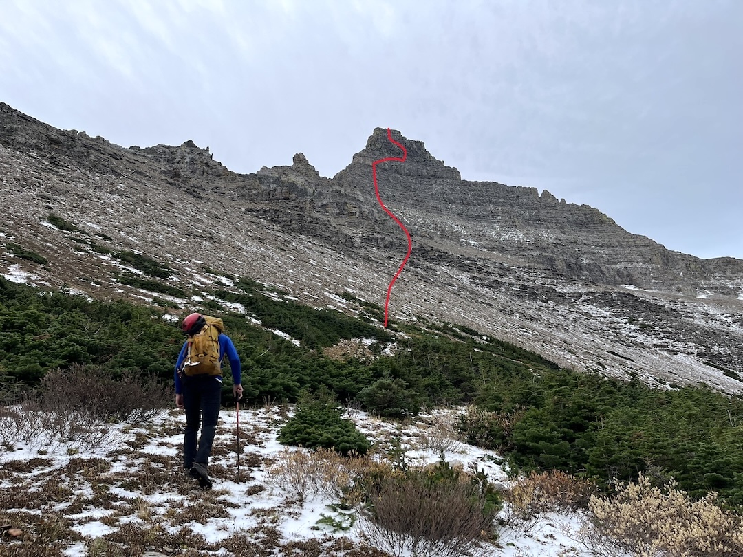 Adam Clark approaching the north face of Flinsch Peak, in Glacier National Park, climbed by David Steele and Adam Clark on October 6, 2024, via a line they named Loaded for Bear (IV 5.8). 