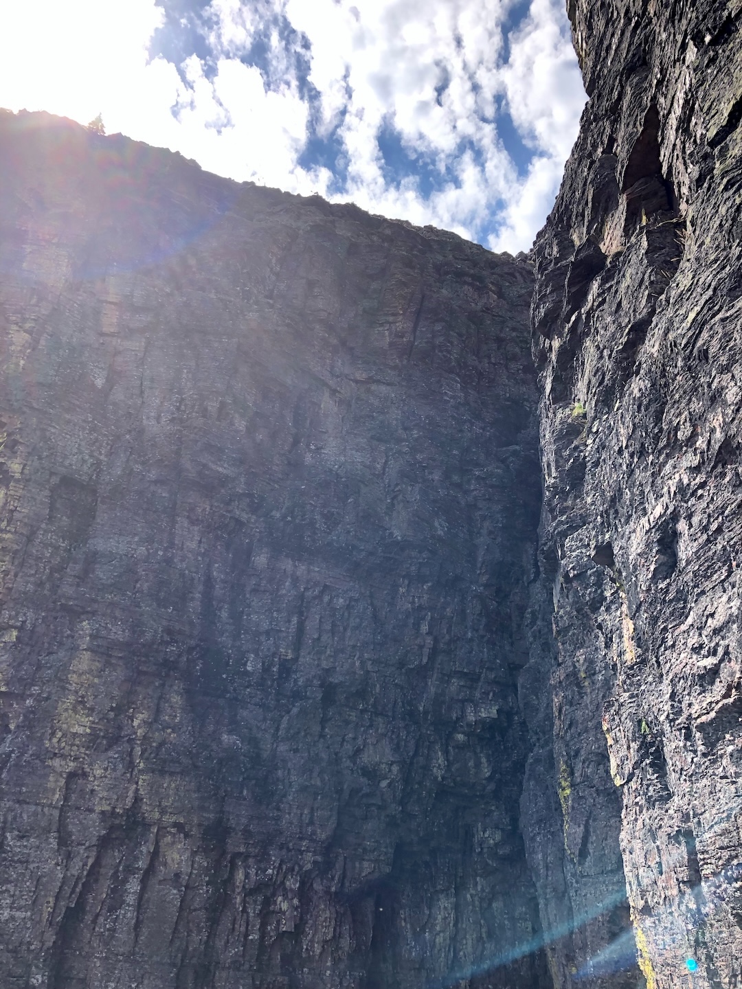 The final pitches of the headwall, from just below “Lunch Ledge” on the east face of Sinopah Mountain. The route stays right of the major corner. 
