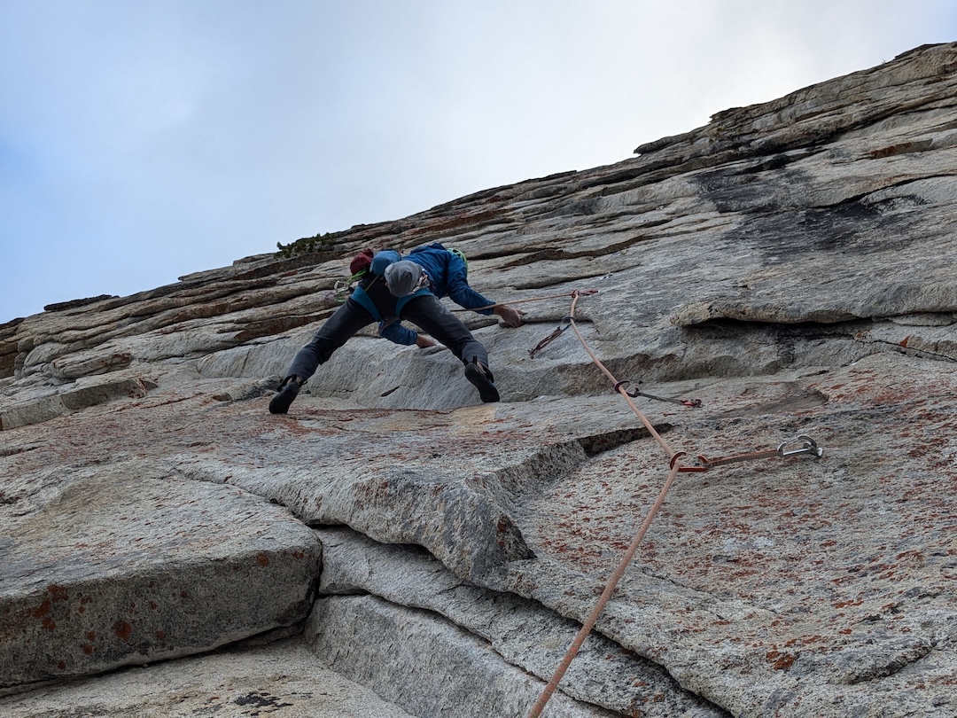 Michal Matyjasik attempting the crux fifth pitch (5.13b) of Pika Paradise on a cold day. 