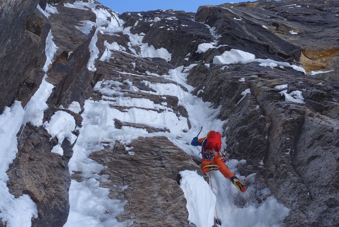 Tom Livingstone climbing steep névé on an attempt at the west face of Peak 7,400’ in the Ruth Gorge. He and Gašper Pintar bailed when they hit a large roof about two-thirds of the way up the face and couldn’t traverse around it.