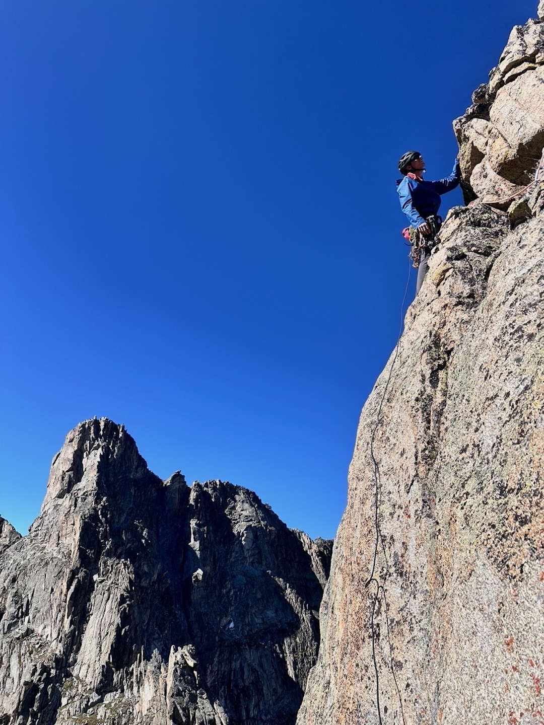 Luc Aurand on moderate terrain on the last pitch of East Dihedrals (750’, 5.10d). The peak in the back is commonly known as Iroquois. 