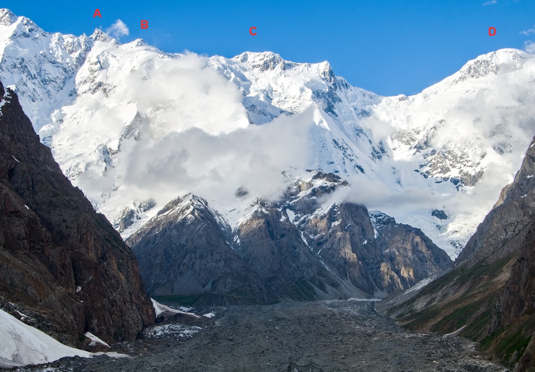 The eastern Batura Wall from the Muchuhar Glacier. (A) Batura V. (B) Batura VI. (C) Muchu Chhish. (D) Passu Sar. The spur climbed in 2024 to reach the ridgeline is just left of center and mostly obscured by cloud. 
