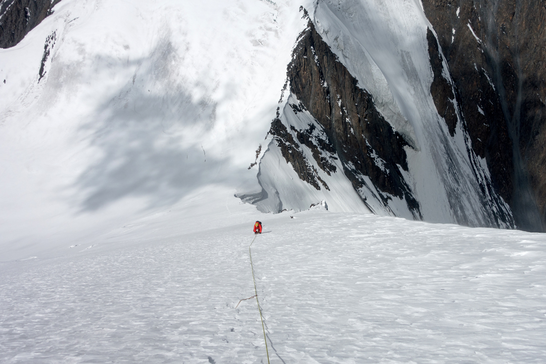 Murilo Lessa halfway up the west face of Yazpurs Sar, with Yazpurs Col below. 