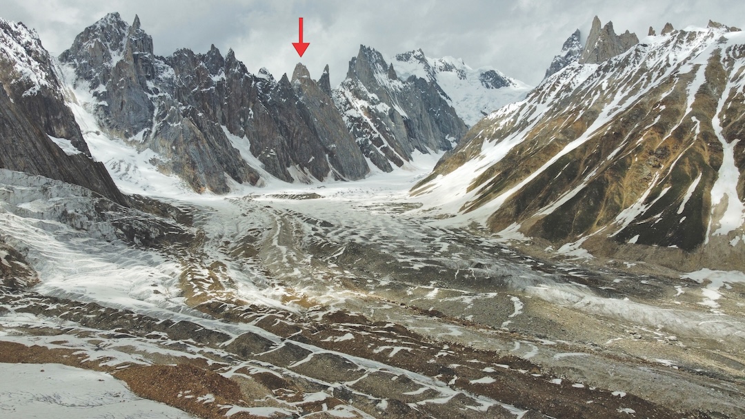 Looking up the South Sosbun Glacier at the Sosbun Spires; the arrow marks Sosbun Spire III (Mun Brakk II). The high, snowy peak at the head of the glacier is Sokha Brakk, while the ridge to the right divides South and North Sosbun glaciers.  