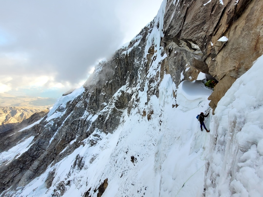 The French climbers rappelled out of their cave bivy to start day two on the south face of Nevado Copa. Puro Floro, also climbed in 2024, breached the left side of the rock wall in back. 