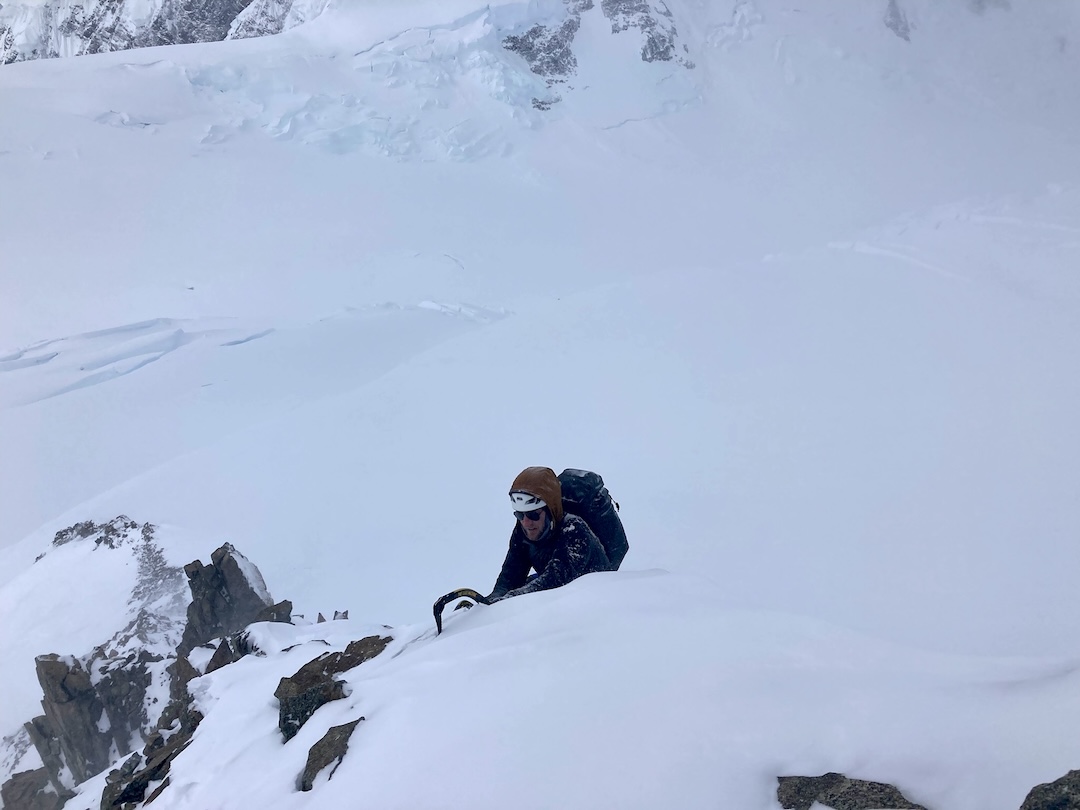Ryan Driscoll pulling onto the ridge during the first ascent of Wizard’s Ridge (800m, Alaska Grade IV).