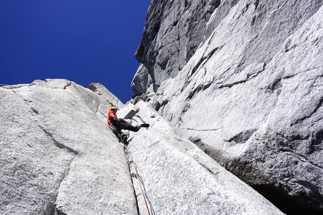 Ryan LaRocque leading on pitch 11 of Rat Race (800m, 5.11+ A1) on the west face of North Howser Tower. 