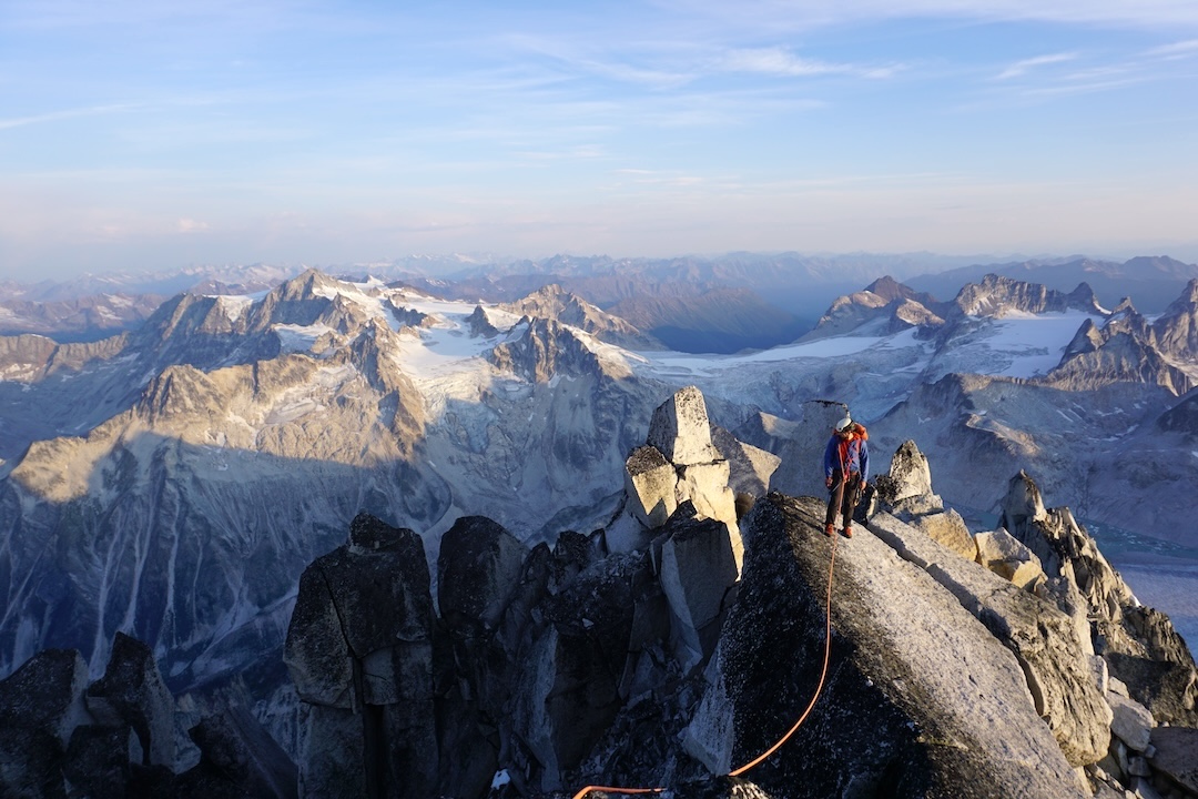 Ryan LaRocque following a pitch near the summit of North Howser Tower at sunset.