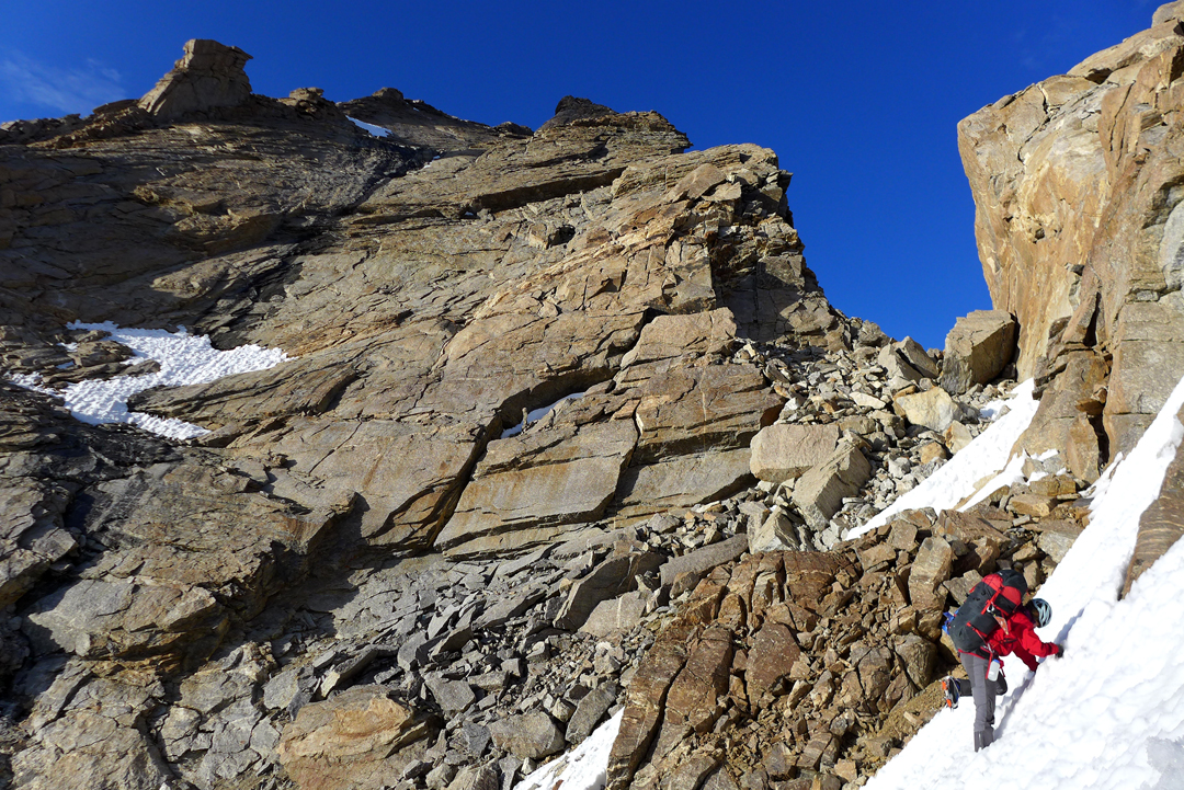 Toward the end of the first day on Starikatchan, Tess Smith approaches the bivouac spot near the top of the west face. The col that marks the start of the south ridge and the technical climbing on the first-ascent route is directly above her. 