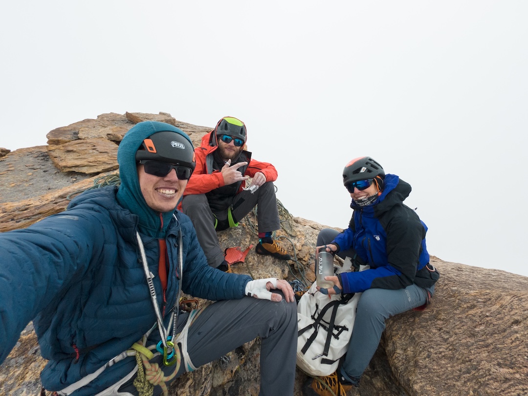 The team at the summit of Chakdor Ri (6,193m) after repeating the route Treasure of Zanskar (Dusic-Zerovnik-Jost, 2017, AAJ 2018). After they had reached the summit in good weather, a storm rolled in and halfway through the descent it began to hail, with lightning striking the glacier below. Having left their boots at the bottom of the route and climbing with rock shoes only, they were relieved to finally reach the base of the wall, change back into mountain boots, and return to camp after 23 hours on the move. 
