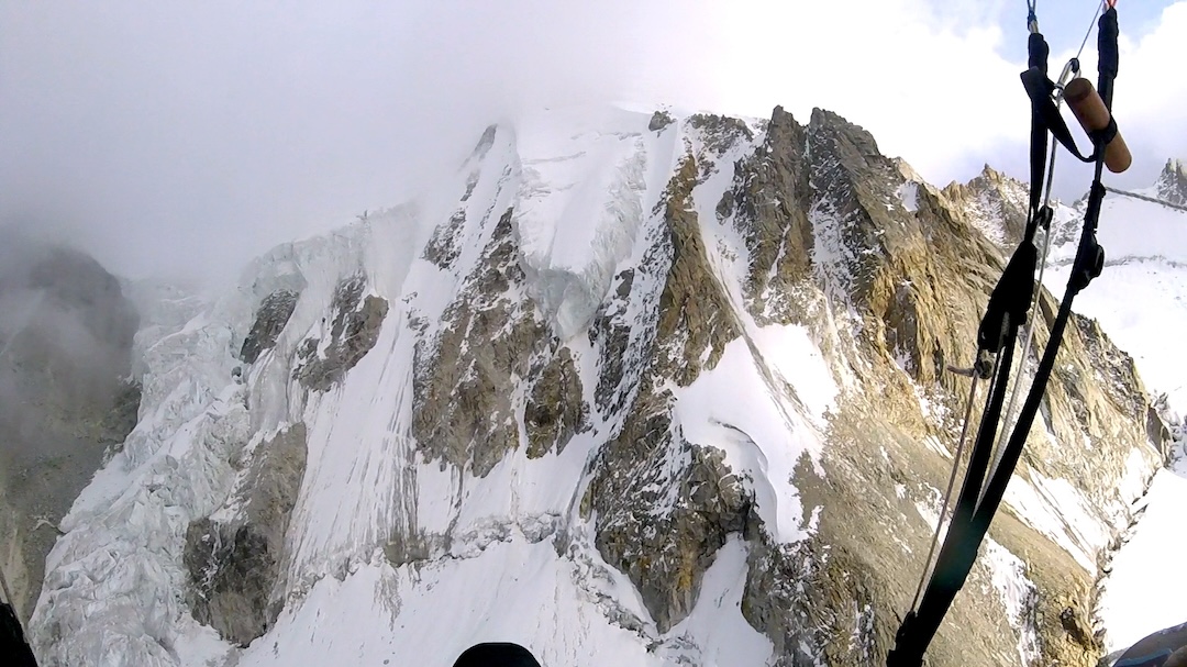 Paraglider view of the northwest face of CB26’s south summit. Juraj Koreň flew to the mountain by paraglider, climbed the obvious snow and ice line on the left to the top, flew down to the glacier for a night in his tent, and then flew back out of the mountains. 

