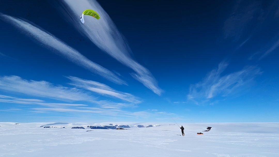 Eric Gilbertson kiting toward the first camp on the peninsula of Umiammakku Nunaat, Greeland.
