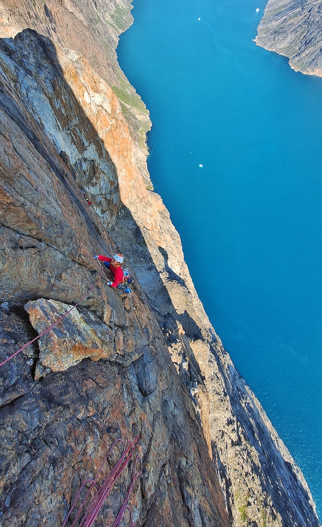 Miška Izakovičová following a sustained pitch on the headwall of Mussels for Tea, Packrafts in the Sea, on the Thumbnail (Maujit Qaqarssuasia). 

 