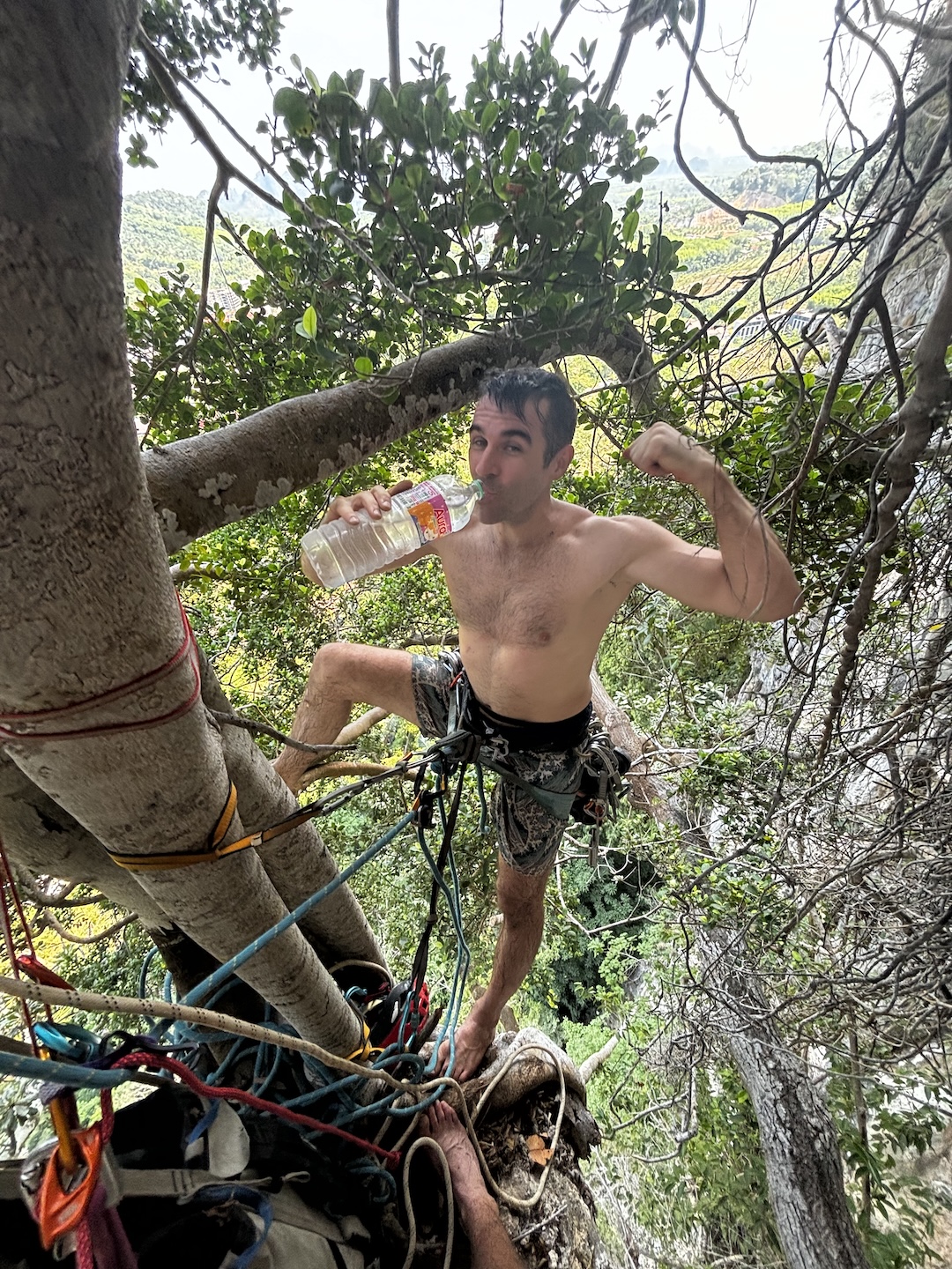 Dave Hood rests at belay after climbing 30 meters up a vine during the first ascent of Fun Dee (5.12a).