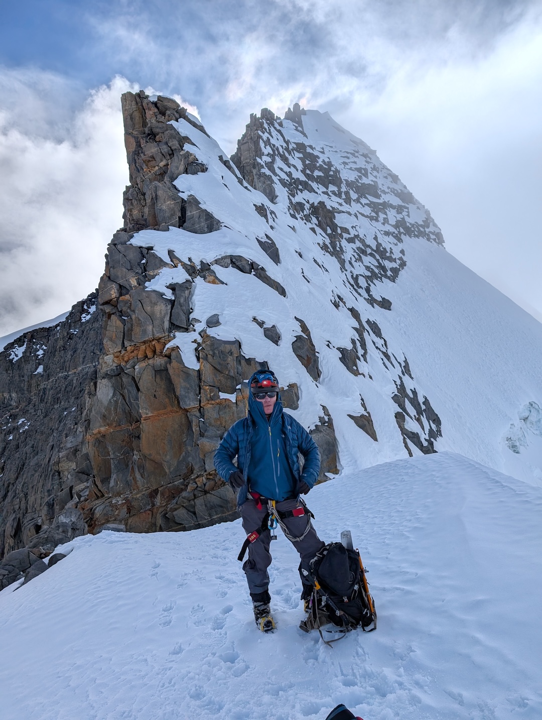 Ginge Fullen at the base of the east ridge of Bolívar from the Bolívar-Colón col. The climbers traversed left across the bottom of two rock steps before gaining the top of the upper rock step and following the ridge to the summit. 
