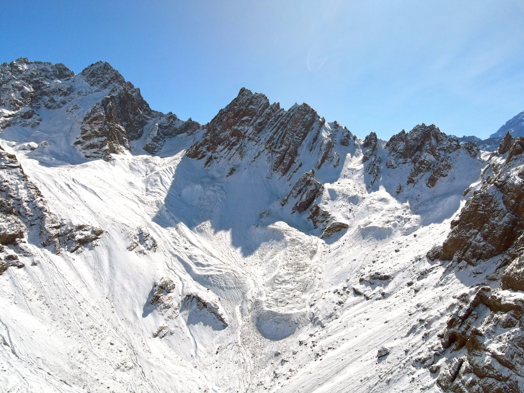 The south face of Cerro De la Iglesia (center). The approach to the east ridge ascended the broad couloir to reach the col right of the peak. The mountain to the left is Cerro Caracoles (4,465m). 