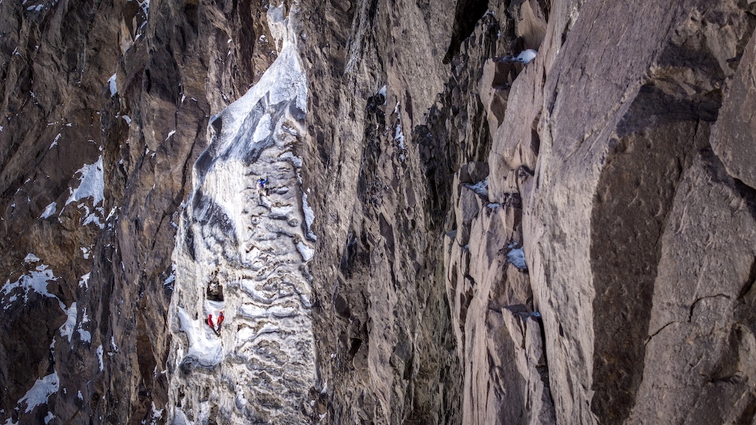 Alexis Rojas leading the fifth ice pitch of the south face of Cerro Tronco. Nicolás Gutiérrez and Cristóbal Cament can be seen at the belay.
