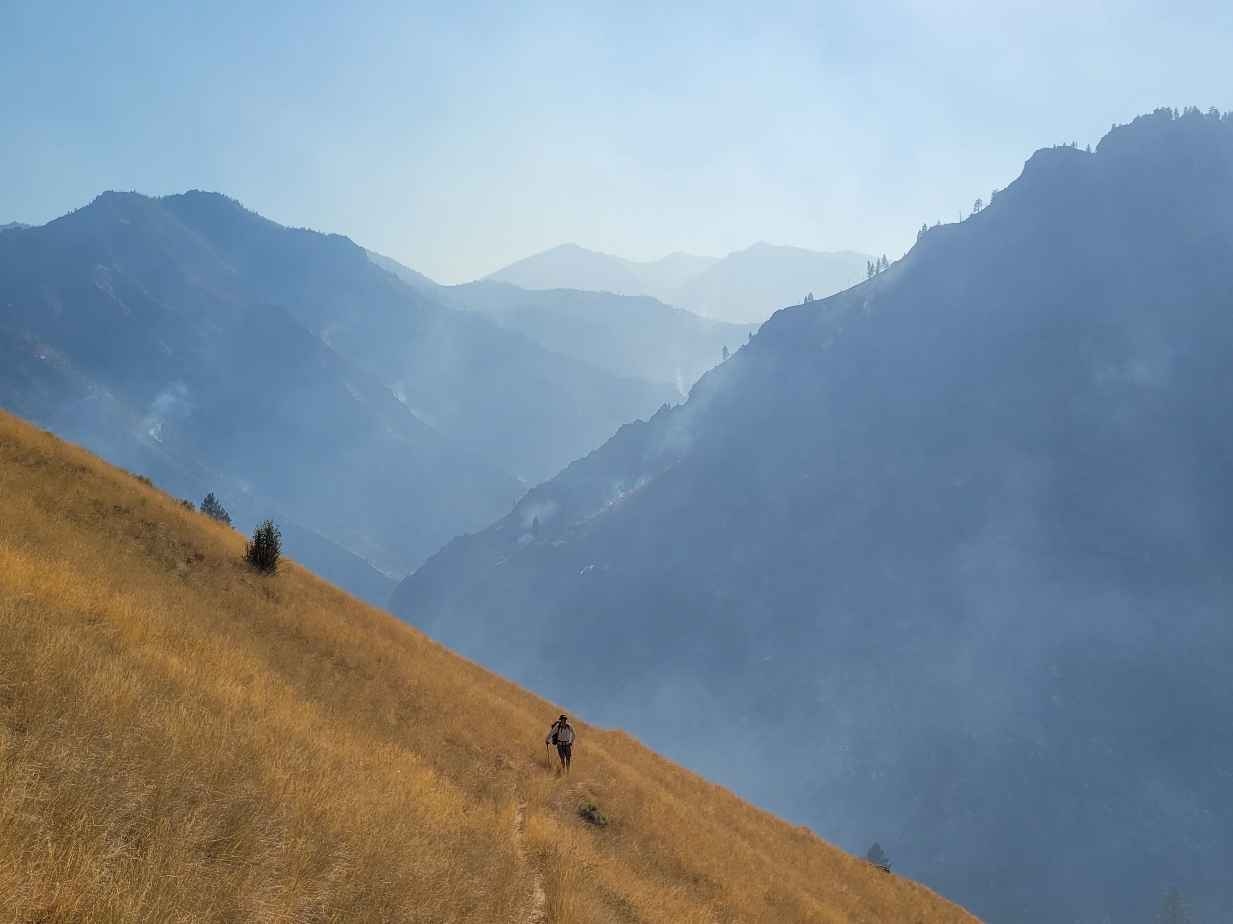 The Big Creek drainage burns in the background as Ky Hart descends the Waterfall Creek Trail toward the Middle Fork of the Salmon River.
