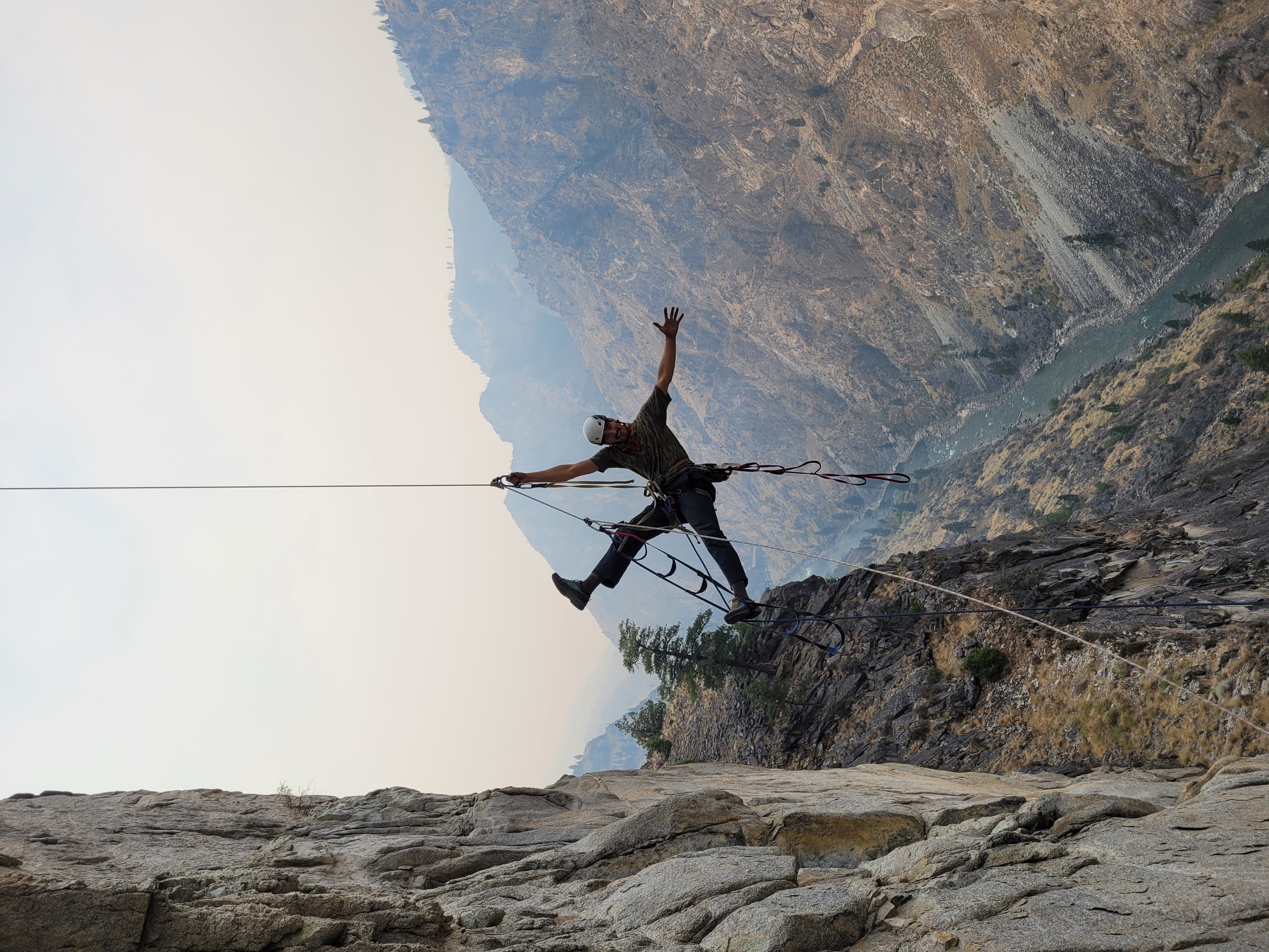 Hart jumaring after the bivouac on the Redside Wall, with the Middle Fork of the Salmon River about 1,500 feet below and wildfire smoke filling the air