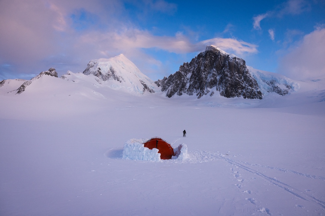 The first morning of seven days in the cirque beneath the twin summits of Cerro Ambrosio Oeste (left) and Este (right) delivered the best visibility Thor Retzlaff and Matthew Tufts had all trip—the weather rapidly deteriorated, and the two were forced to bail and wait another week before their successful ascent and descent of Cerro Ambrosio Oeste. The eastern summit was climbed less than a year later by the southeast ridge (near the right skyline), approached by the glacial slopes to the right. 