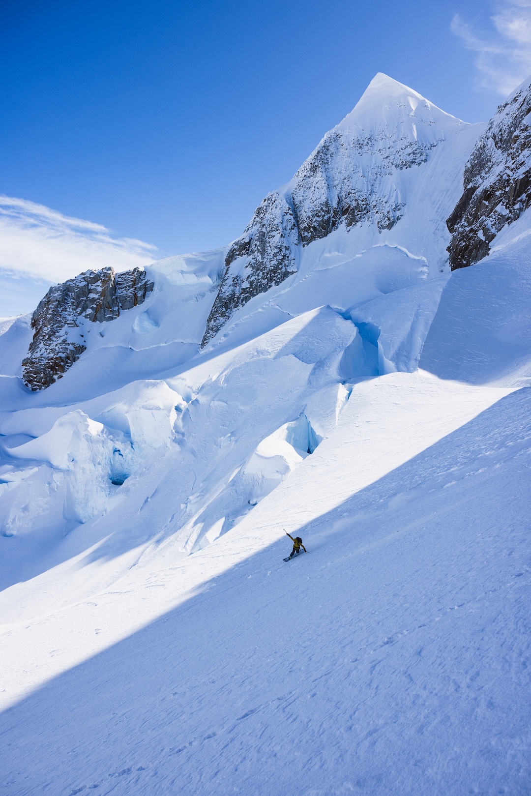 Fer Ferrandez exits the couloir and links large powder turns on the lower glacier down to base camp below Ilse von Rentzall.