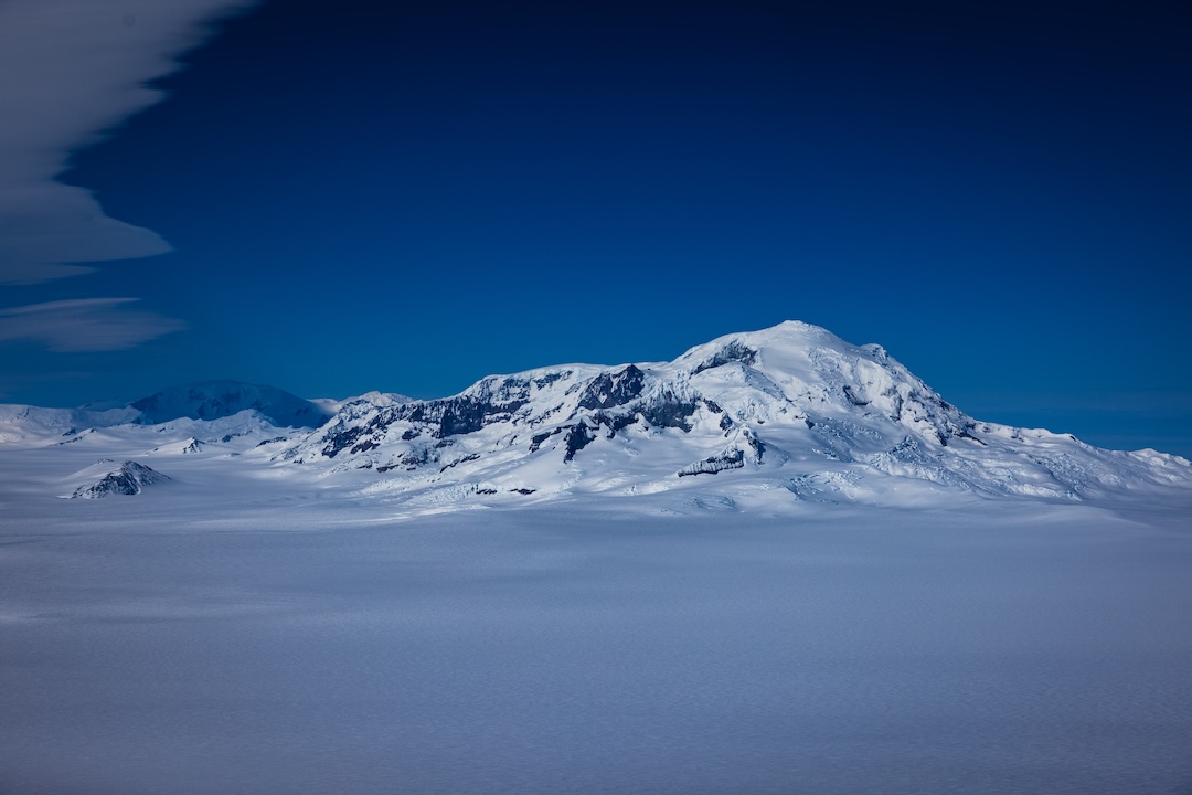 The massive north face of Volcán Lautaro, the highest peak on the Southern Patagonian Icefield. The upper planar headwall is more than 700 meters; the total descent from the summit drops more than 2,200 meters to the icefield below.