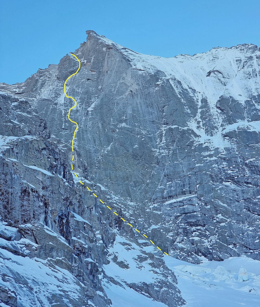 The left side of the northeast face of the Piz Badile in winter with the Battaglia-Corti Route rising out of the northwest couloir of the Colle del Cengalo.