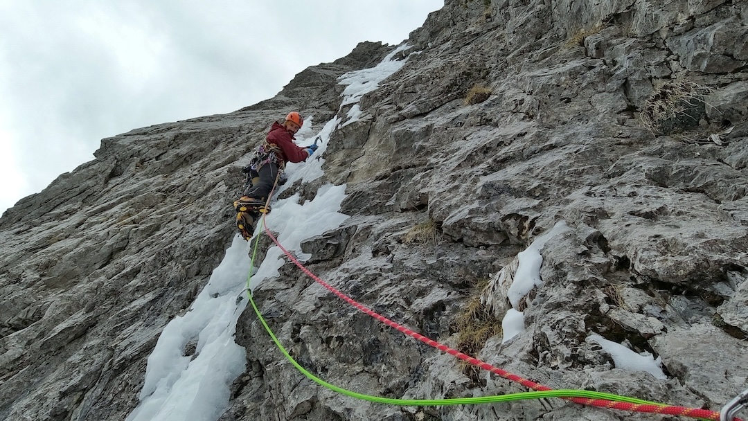 Christos Tsoutsias leading the fourth pitch of Scream of the Butterfly (500m, III AI5 M6+), Tsouka Rossa, Tymfi Massif, tackling mediocre, poorly protected névé warmed by the south wind.  