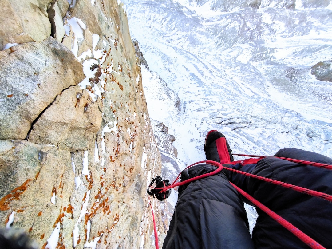 Jumaring fixed ropes beneath a roof on the Mikhailov Route, Box Peak. 